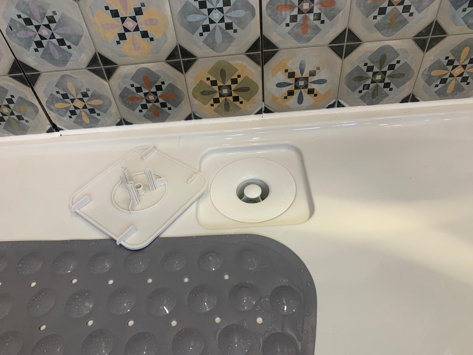 Bath overflow fitting before detailed bathroom cleaning