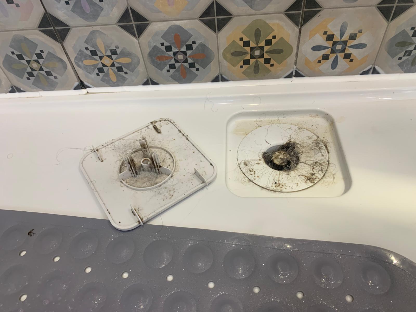 Bath overflow fitting after detailed bathroom cleaning